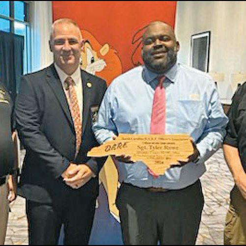 ROWE WINS STATE D.A.R.E. OFFICER OF THE YEAR — School Resource Officer (SRO) Sgt. Tyler Rowe, of the Alexander County Sheriff’s Office, was named the North Carolina D.A.R.E. Officer of the Year for 2024. Rowe was honored at the state D.A.R.E. Officers’ formal banquet on June 13, 2024, in Cherokee, NC. Pictured above, left to right: SRO Lt. Buddy McKinney, Sheriff Chad Pennell, Sgt. Rowe, and Maj. Mark St. Clair.
