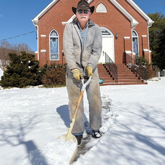 Larry Herman shoveling Mt Olive Ch sq